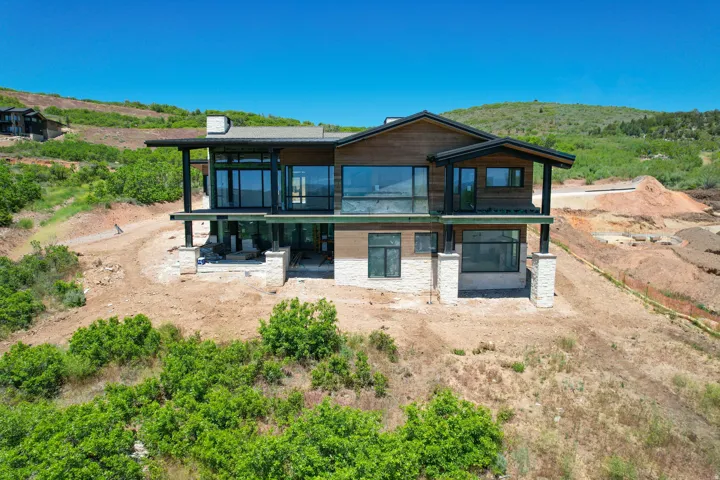 Hillside residence featuring a multi-level design with extensive glazing