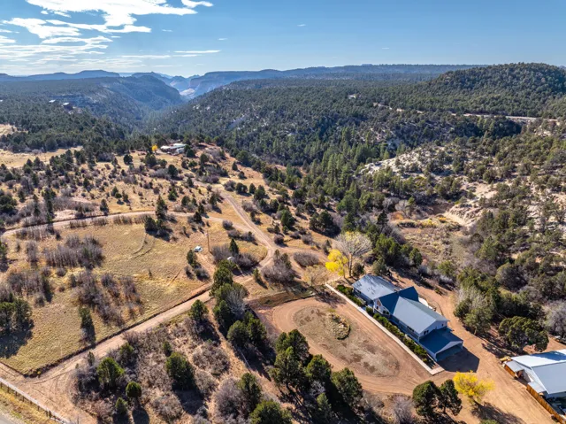 Aerial overview of property's location featuring a mountain backdrop
