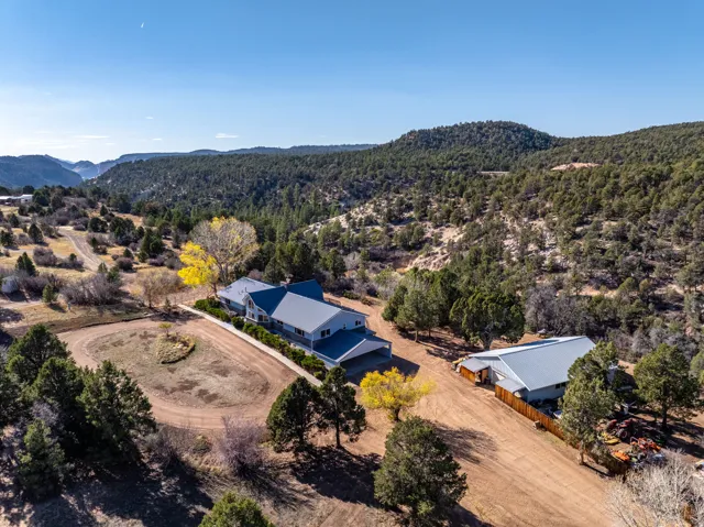 Aerial view of property and surrounding area with a mountainous background