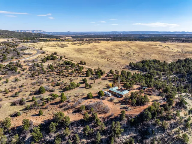 Aerial view of property and surrounding area with mountains and rural landscape