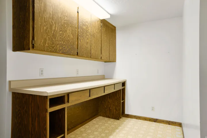 Laundry room with light flooring and baseboards