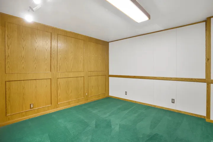 Unfurnished room featuring dark colored carpet
