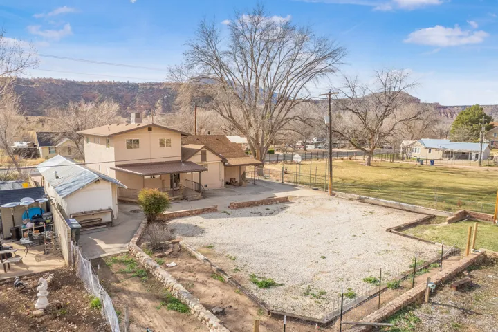 Fenced yard featuring a patio area, a mountain view, and driveway