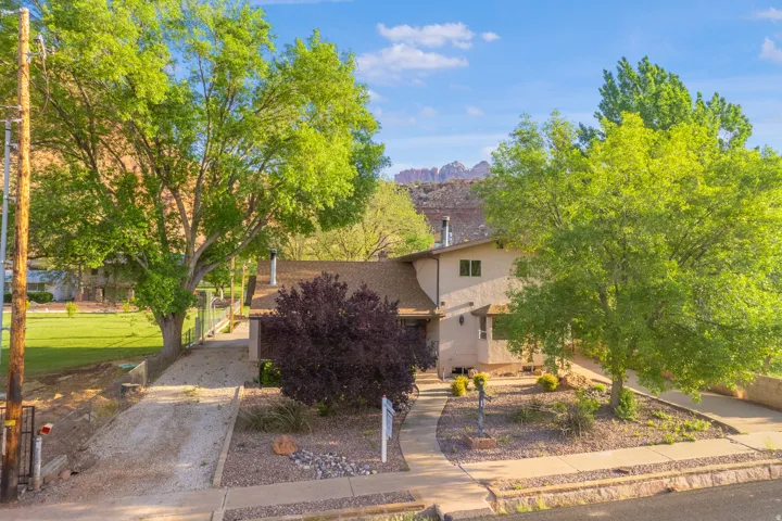Obstructed view of property with stucco siding and a mountain view
