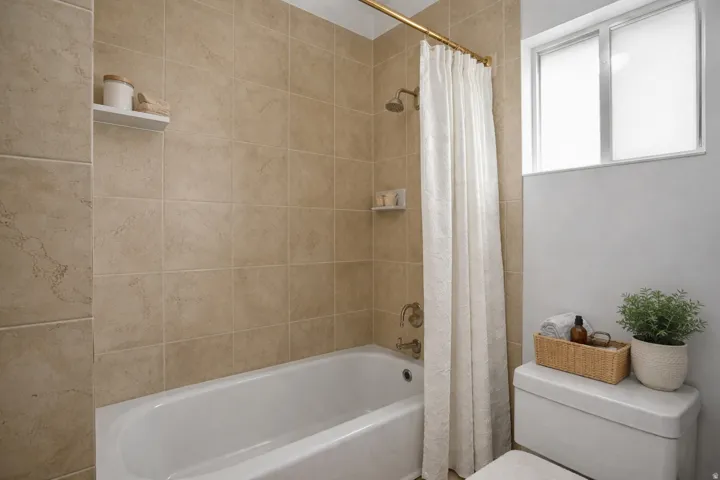 Full bathroom featuring toilet and shower / tub combo