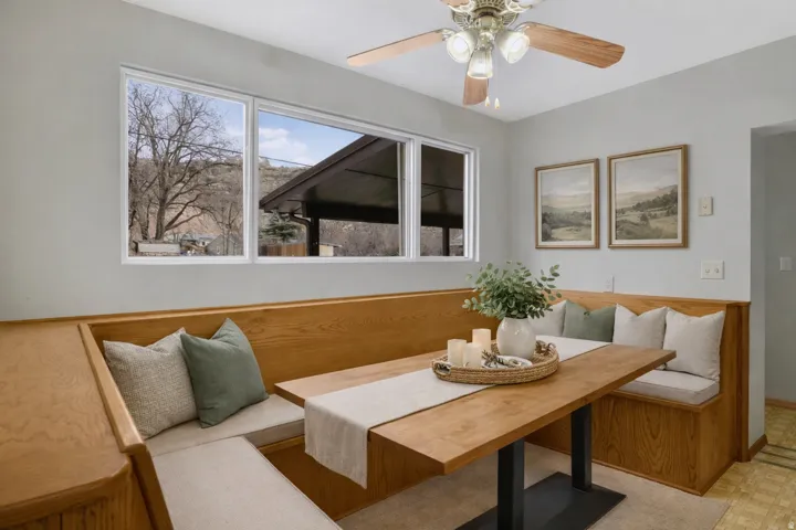 Dining area with breakfast area, light floors, and a ceiling fan