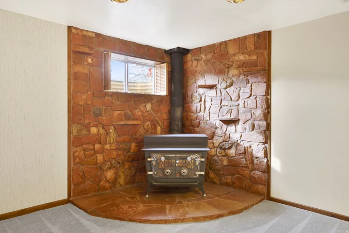 Detailed view of a wood stove and carpet flooring