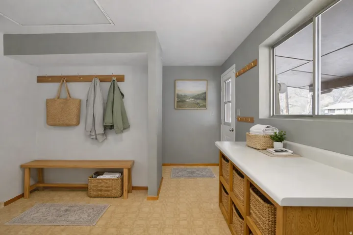 Mudroom featuring light flooring and baseboards