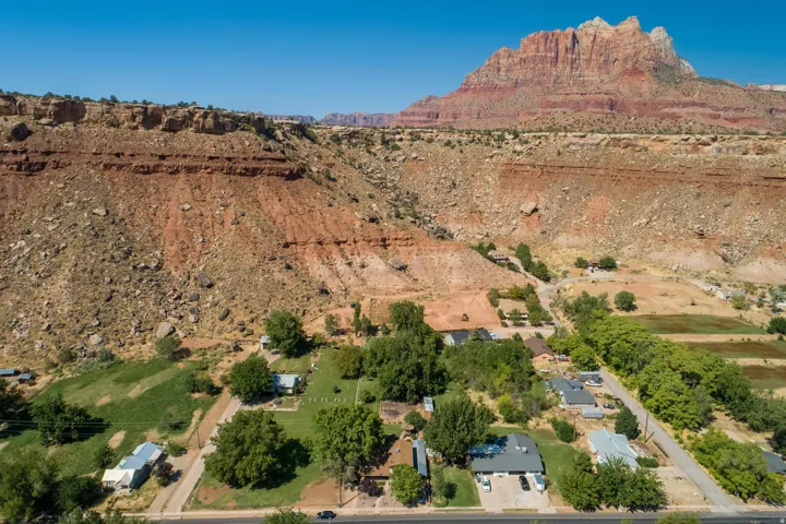 Aerial view of sparsely populated area with mountains and a desert landscape