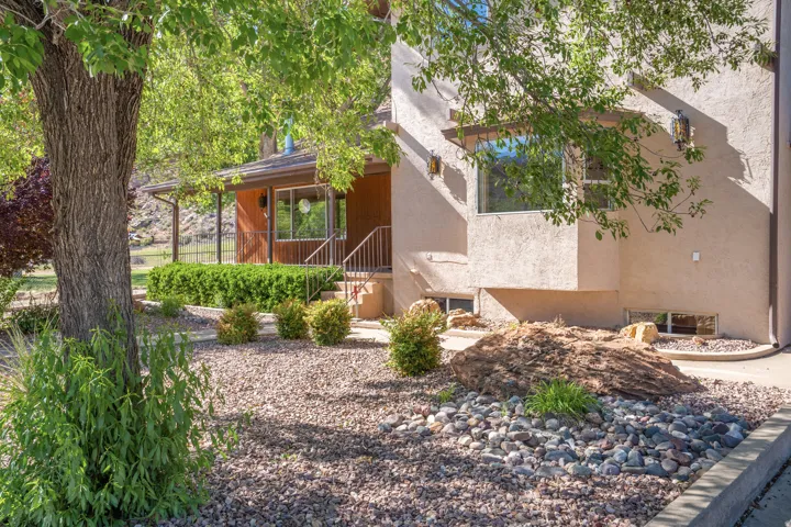 View of side of property featuring stucco siding and a porch