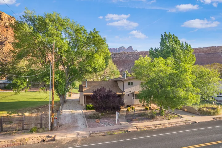 Obstructed view of property with a fenced front yard