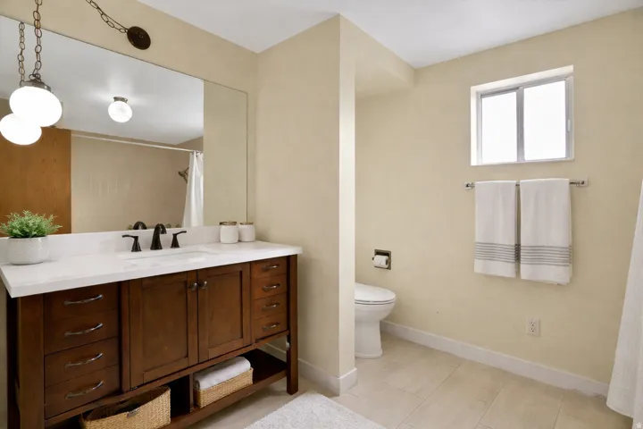 Full bathroom with vanity and a shower with shower curtain