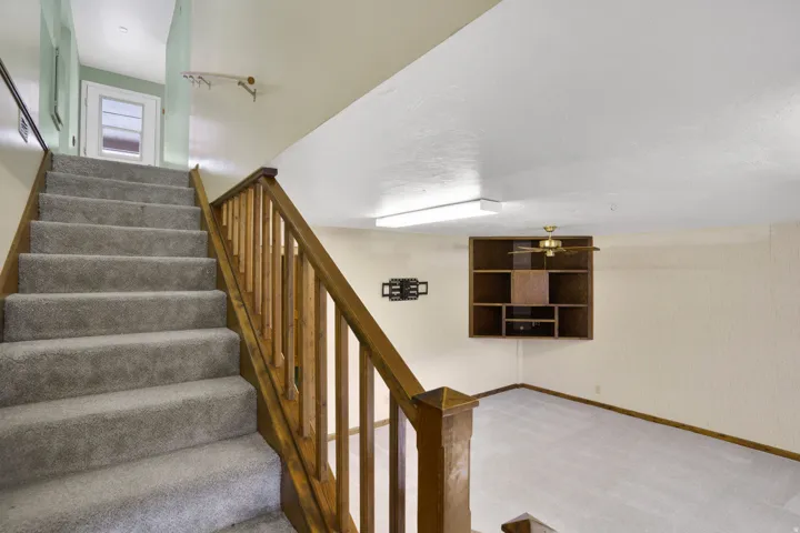 Stairway with carpet floors and baseboards