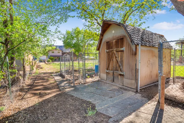 View of shed featuring a gate