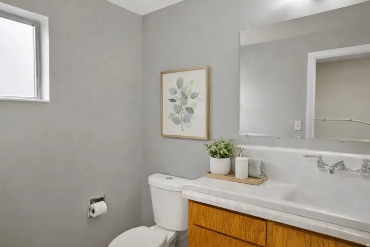 Half bath featuring toilet and vanity