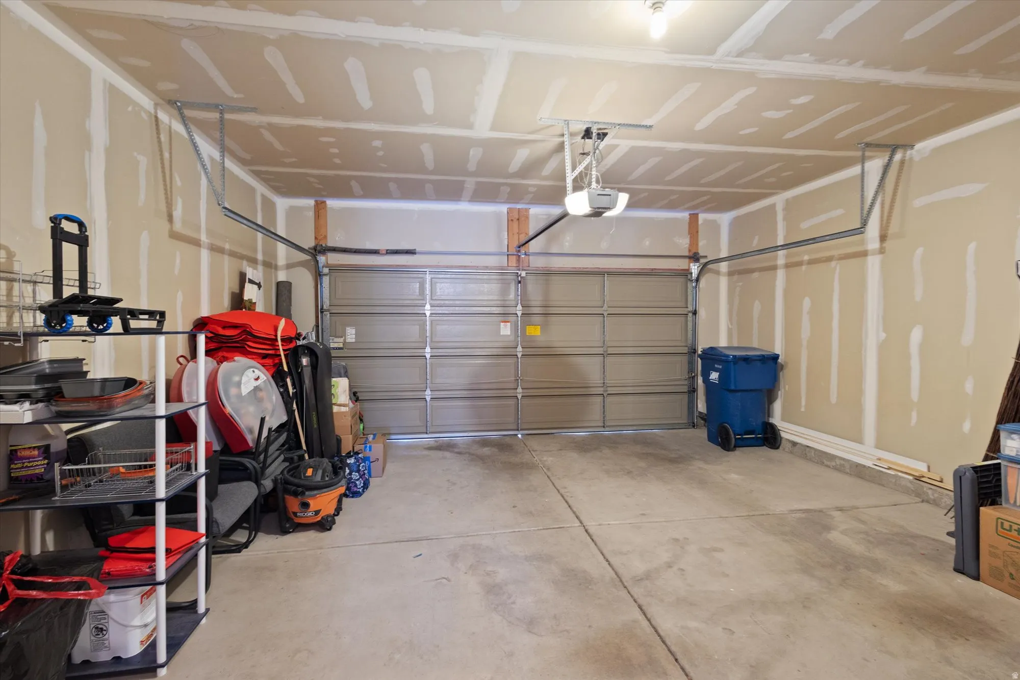 Garage featuring a garage door opener
