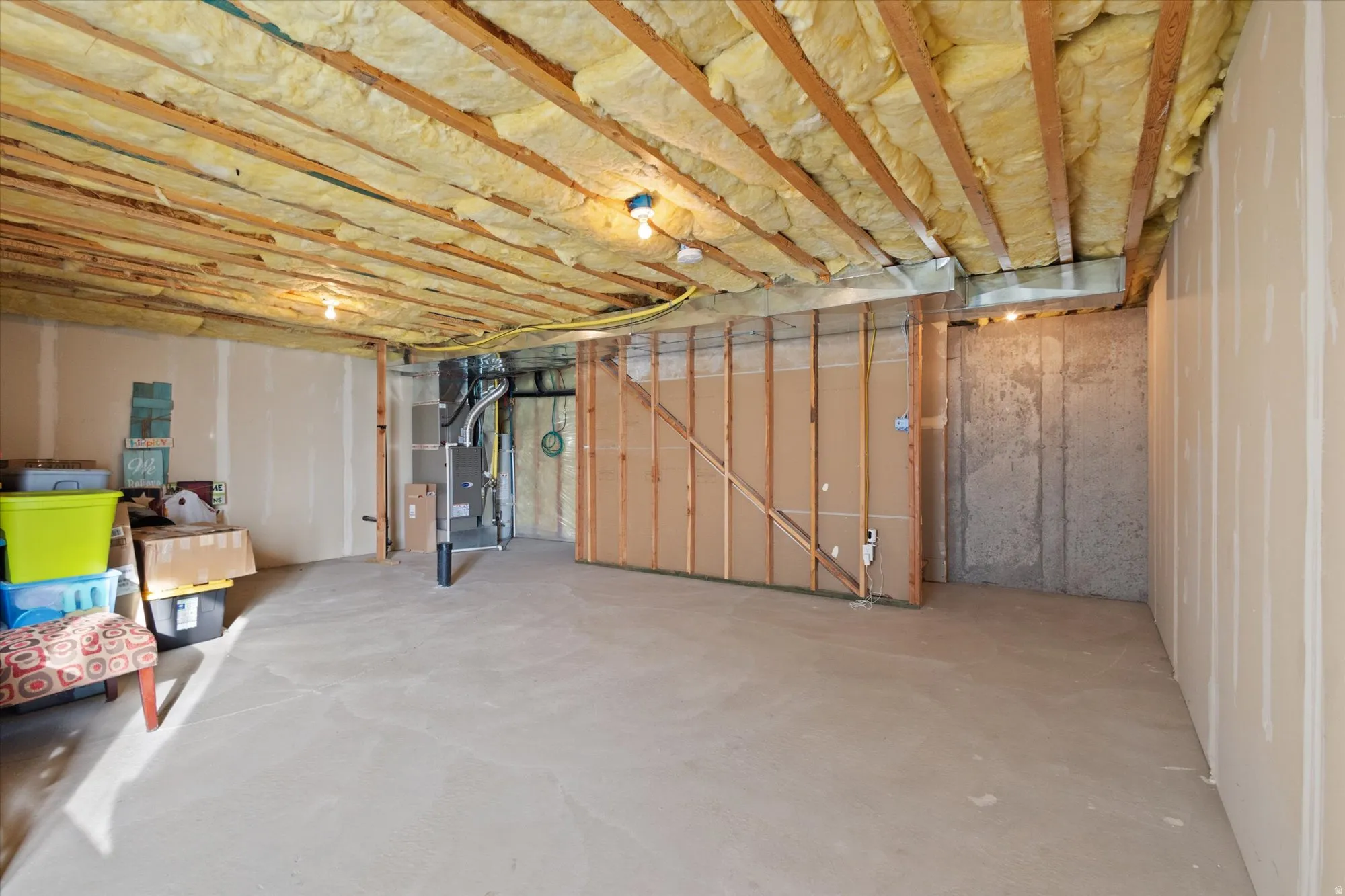 Unfinished basement featuring heating unit