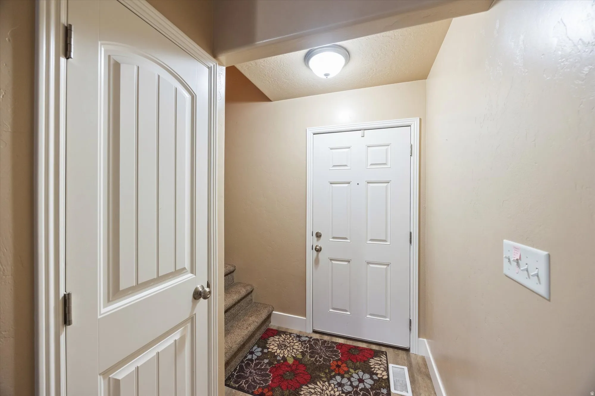 Entryway featuring a textured ceiling and stairs