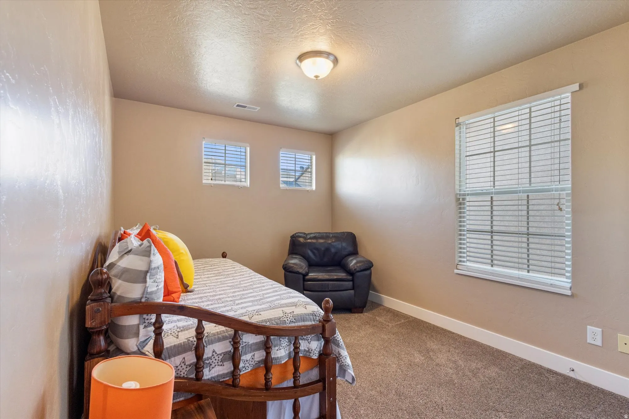 Carpeted bedroom with baseboards and a textured ceiling