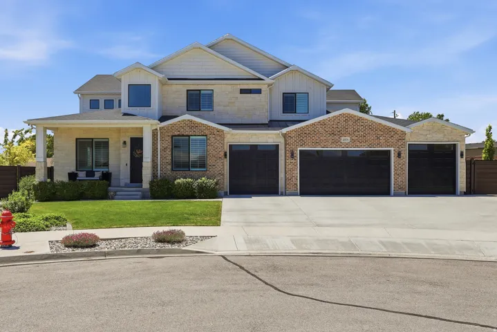 Multi-level exterior featuring light-toned stone and brick accents