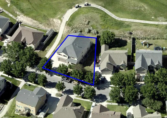 Aerial view of residential area with property parcel outlined