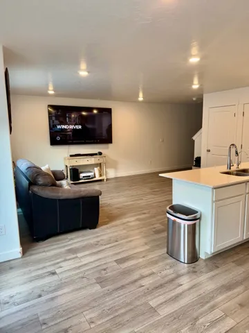 Living area featuring light wood-style floors and recessed lighting