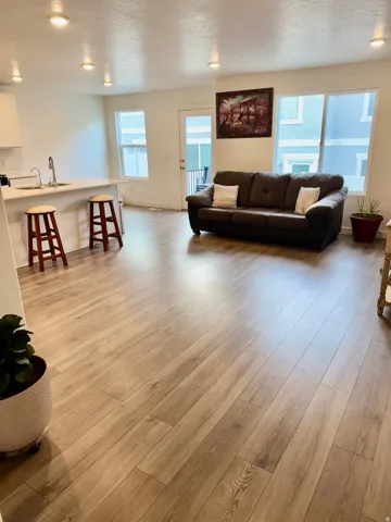 Living room with light wood-style flooring and a textured ceiling