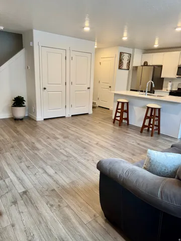 Living area with light wood finished floors and baseboards