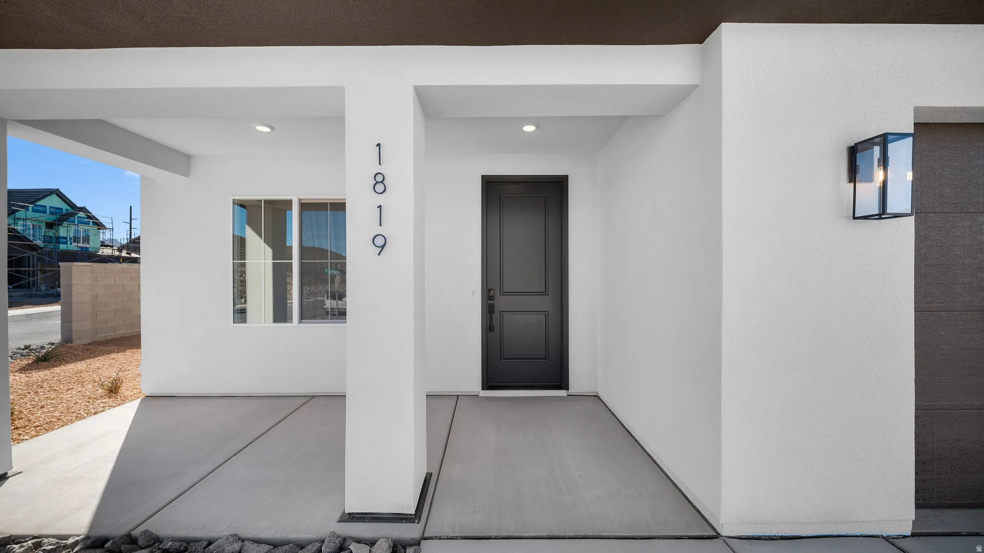 Property entrance featuring a porch and stucco siding