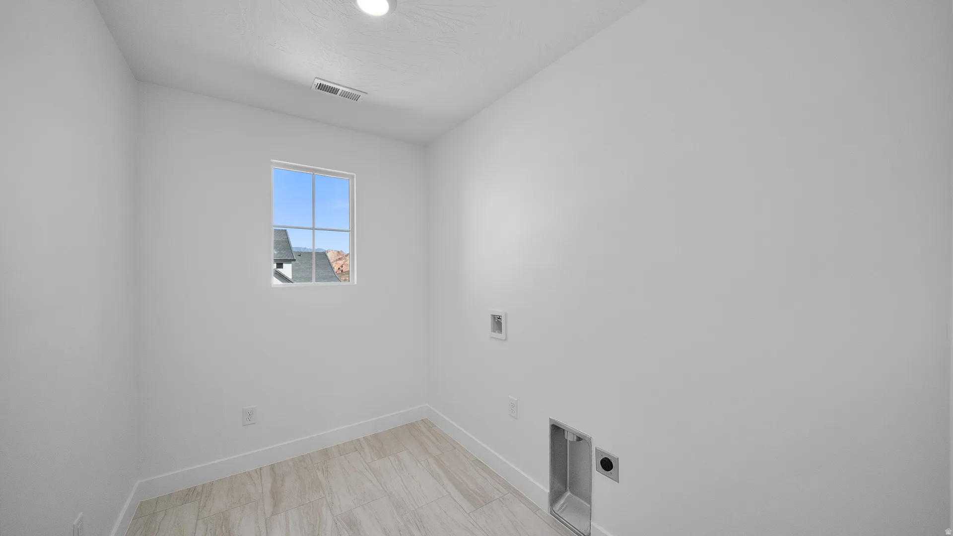 Laundry room with hookup for a washing machine and electric dryer hookup