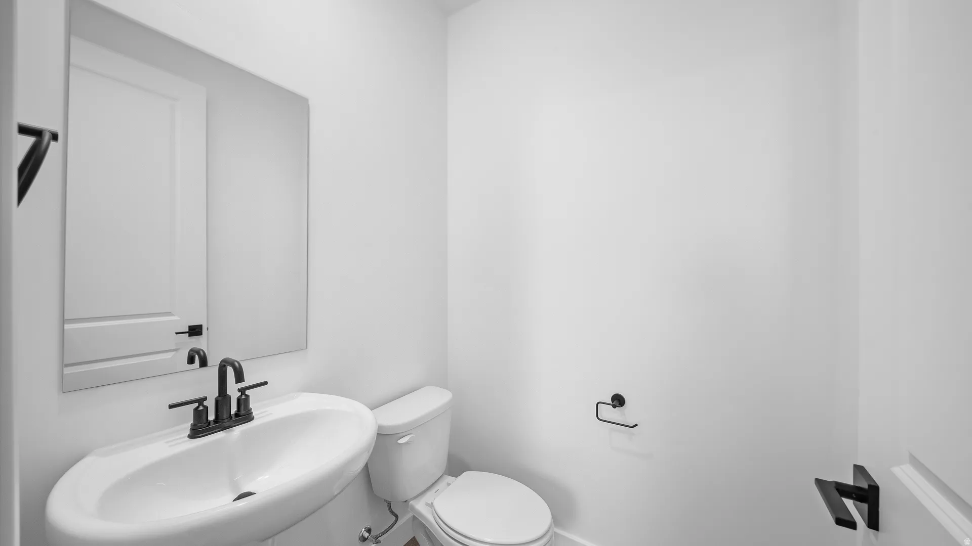 Half bathroom with toilet and a sink