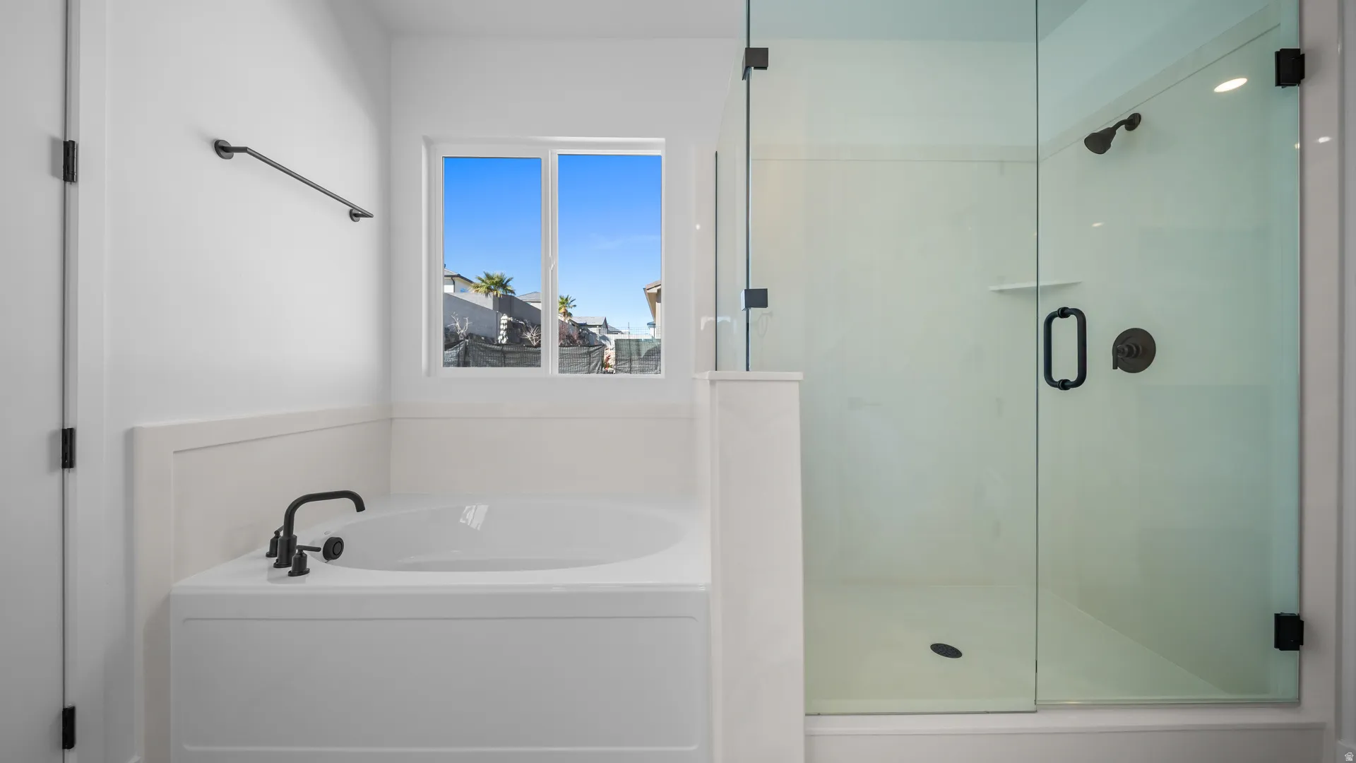 Bathroom with a stall shower and a bath