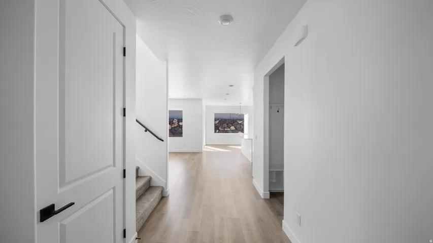 Corridor with stairway and light wood-type flooring