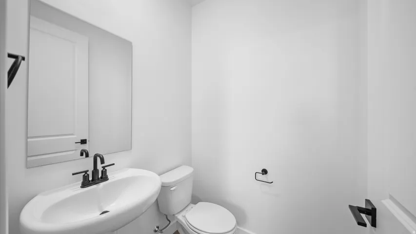 Half bathroom with toilet and a sink