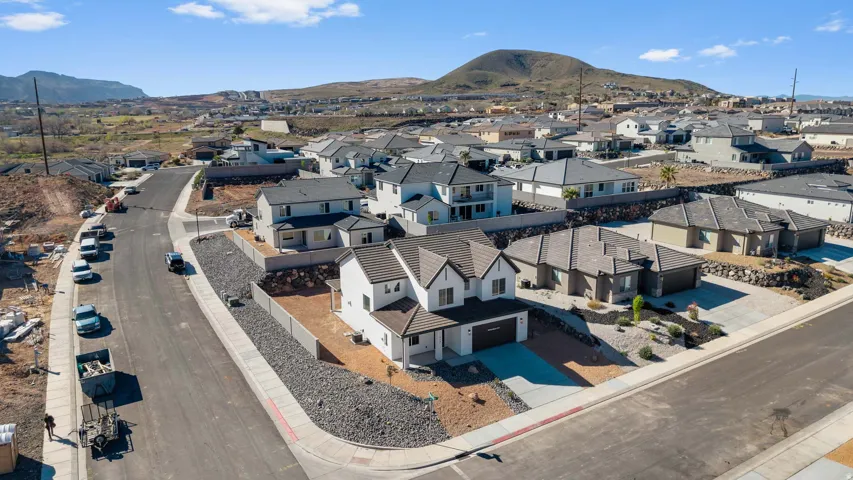 Aerial perspective of suburban area with a mountainous background