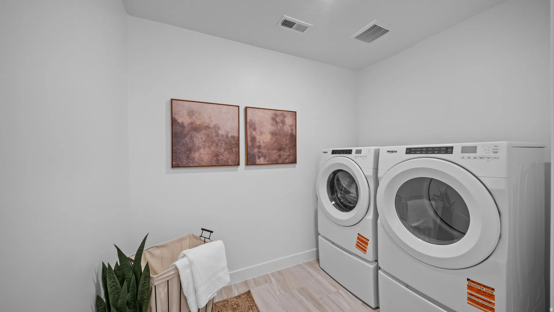 Laundry area with washer and dryer and baseboards