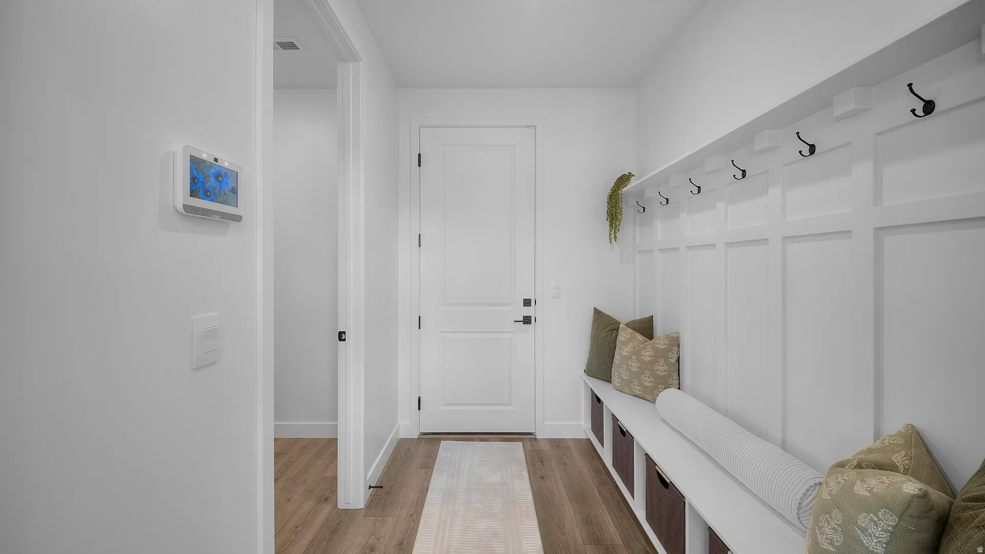 Mudroom featuring light wood finished floors