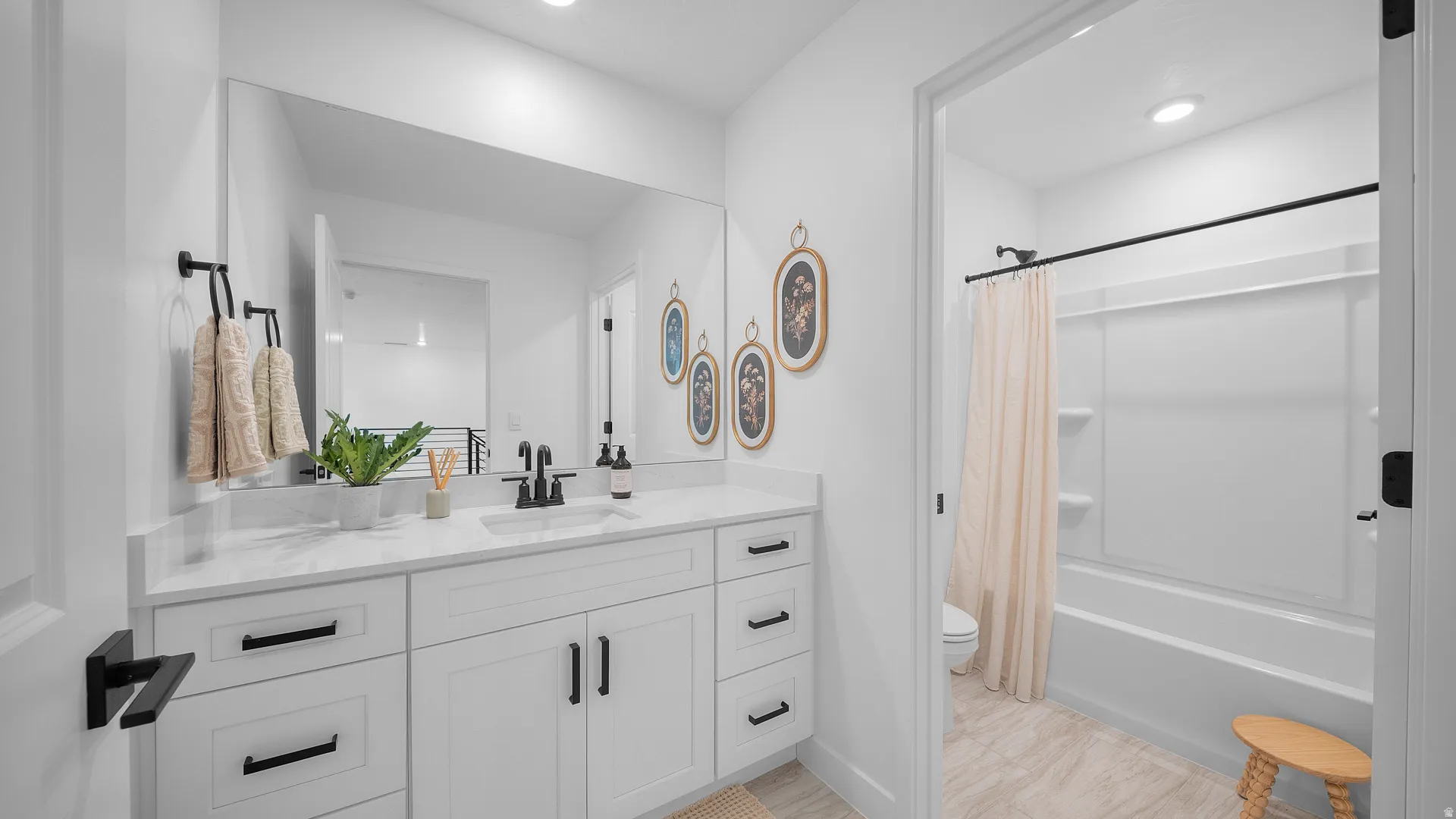 Full bath featuring vanity and shower / tub combo