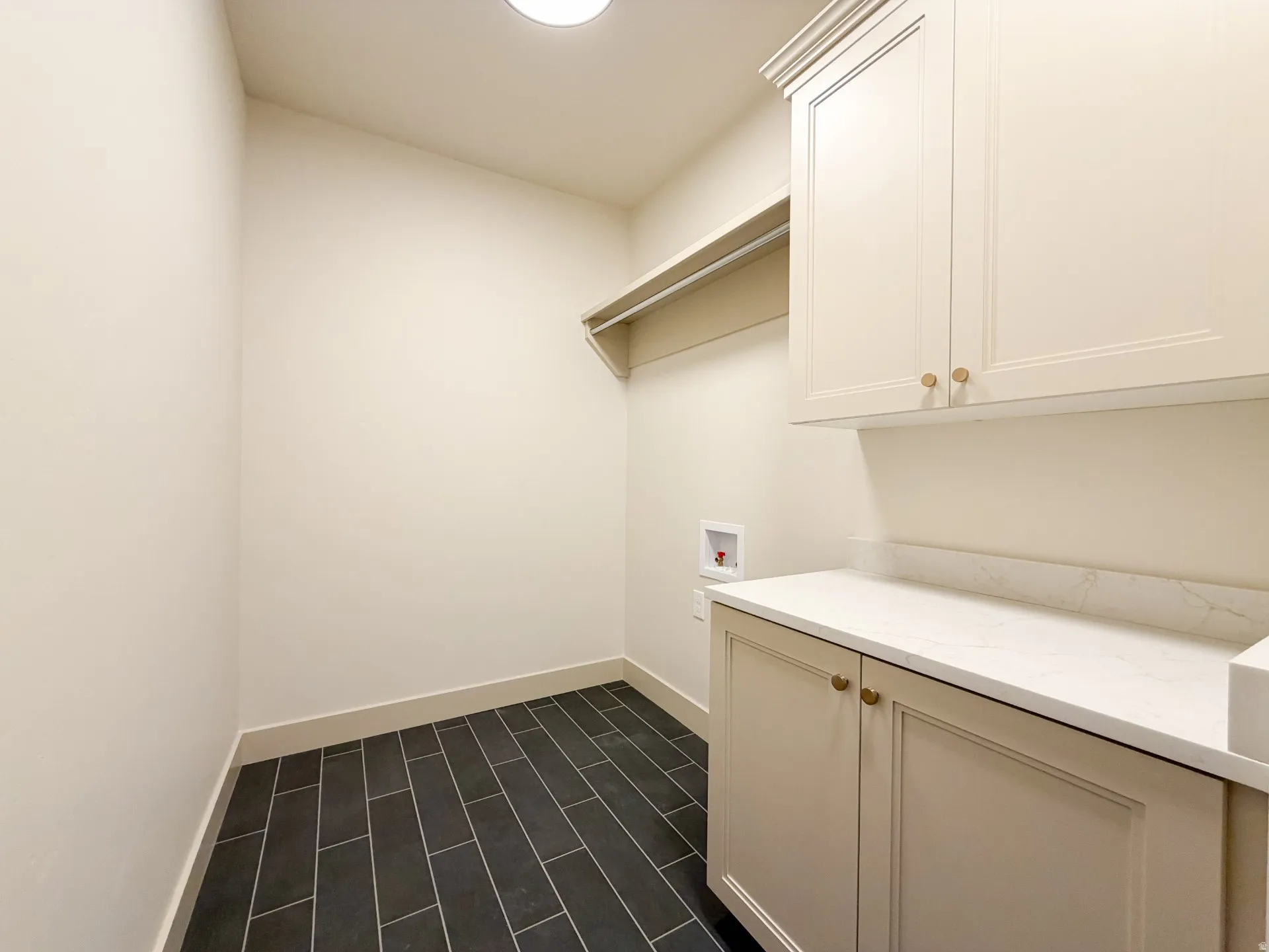 Laundry area with washer hookup and cabinet space