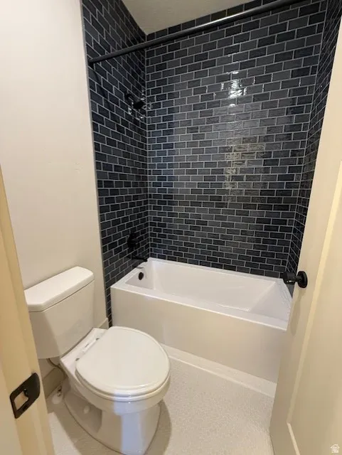 Bathroom featuring toilet and shower / bathtub combination