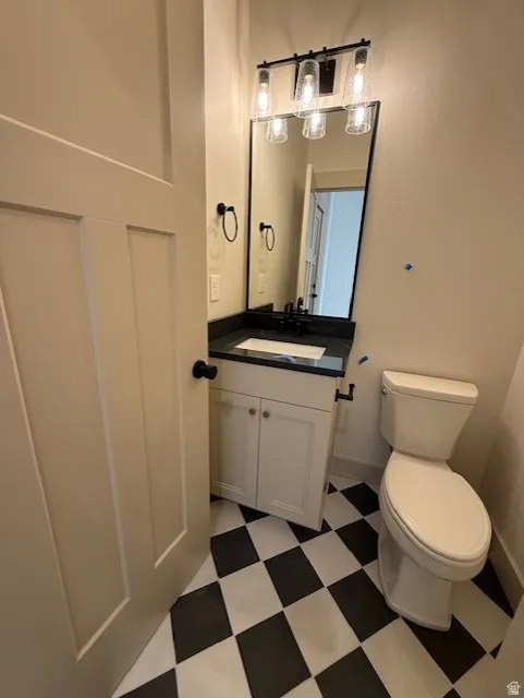 Half bath featuring vanity and light floors