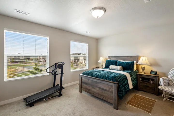 Bedroom with carpet floors and a textured ceiling