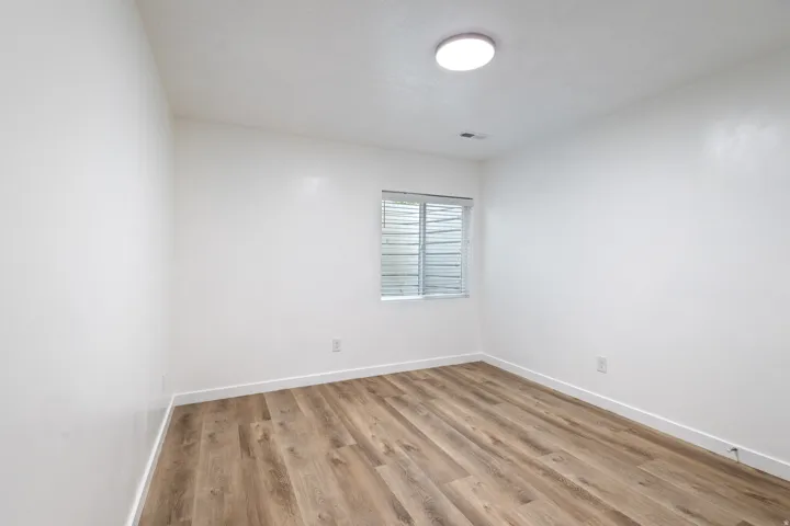 Unfurnished room featuring baseboards and light wood finished floors