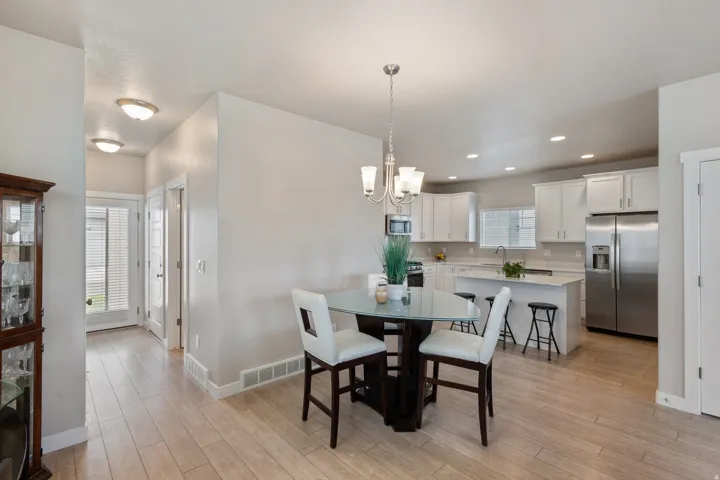 Dining area featuring light wood-type flooring, a chandelier, and recessed lighting