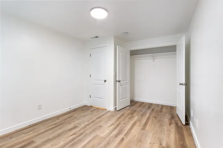 Unfurnished bedroom featuring light wood-type flooring and a closet
