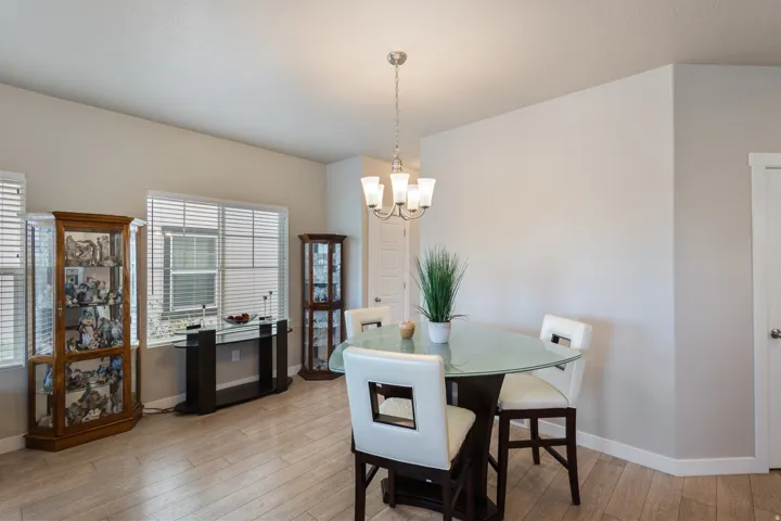 Dining space featuring light wood-type flooring and a chandelier