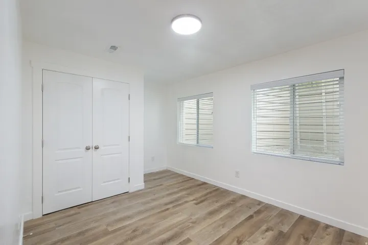 Unfurnished bedroom with light wood finished floors and a closet