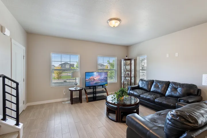 Living area with light wood-style floors, healthy amount of natural light, and a textured ceiling