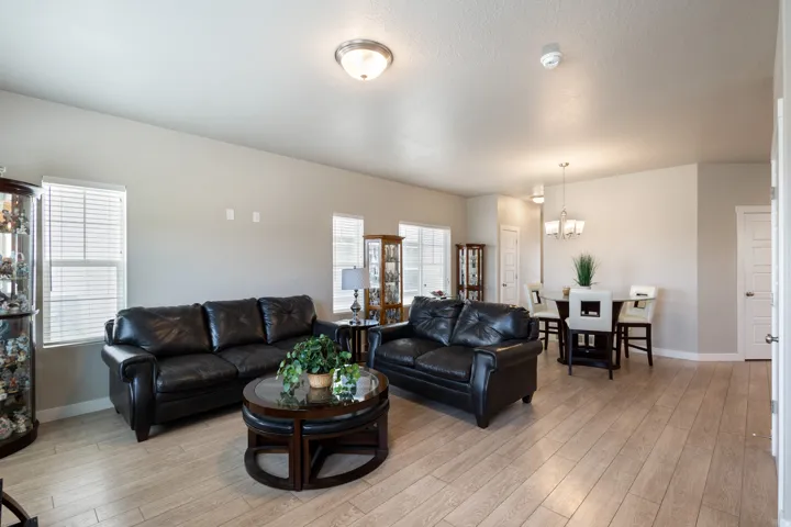 Living room with light wood-type flooring and a chandelier