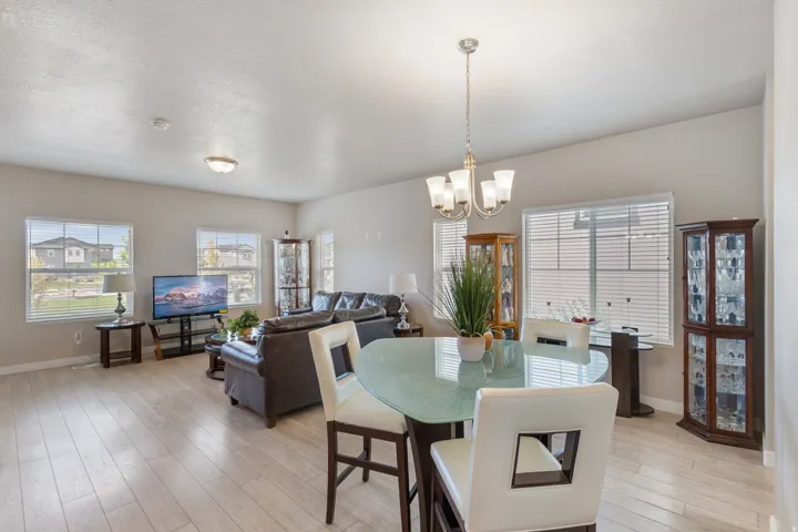 Dining area with light wood-type flooring and a chandelier